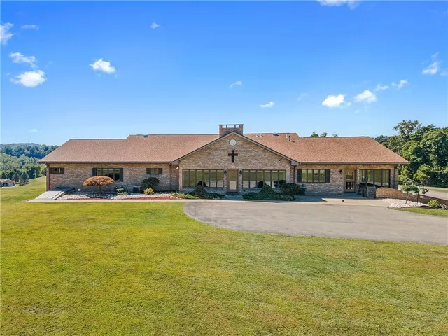 a view of a house with swimming pool and a yard