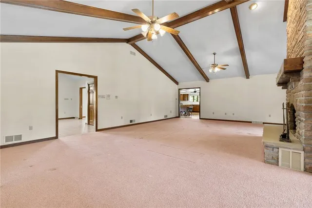 a view of a livingroom with a ceiling fan and entryway