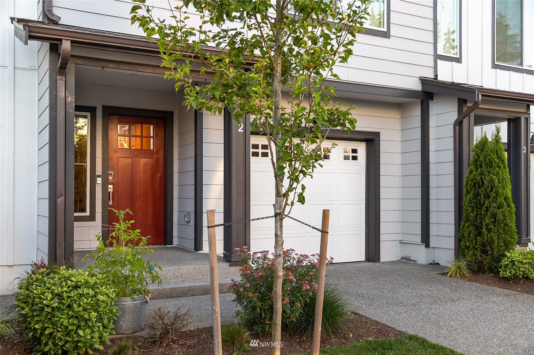 2002 101st Avenue Southeast, Unit 2 Lake Stevens, WA 98258 - Photo 1 of 22 a front view of a house with a yard