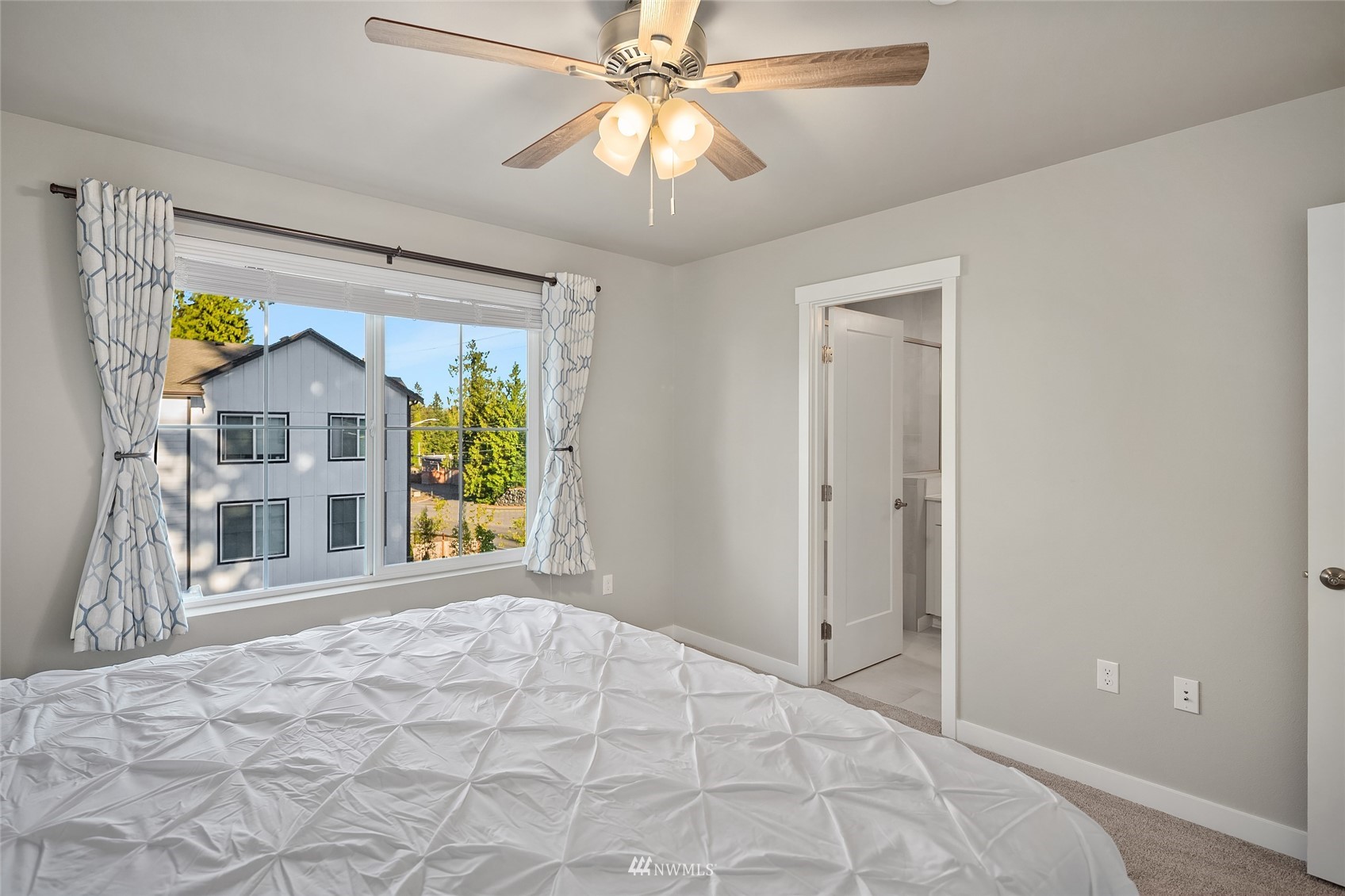 2002 101st Avenue Southeast, Unit 2 Lake Stevens, WA 98258 - Photo 20 of 22 a view of a bedroom with a bed and a chandelier fan