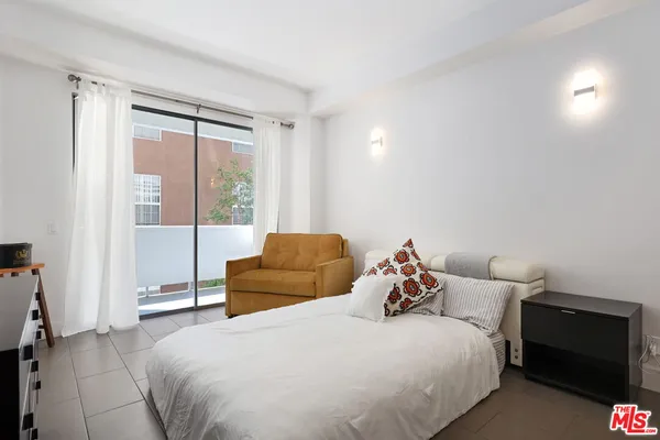 a bedroom with a bed and a couch