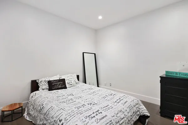 a bathroom with a toilet a sink and a mirror