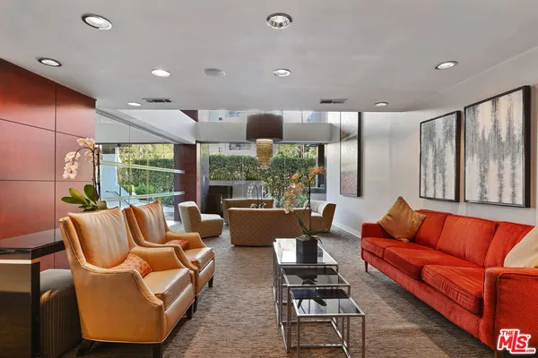 a kitchen with stainless steel appliances kitchen island granite countertop a refrigerator and a stove top oven