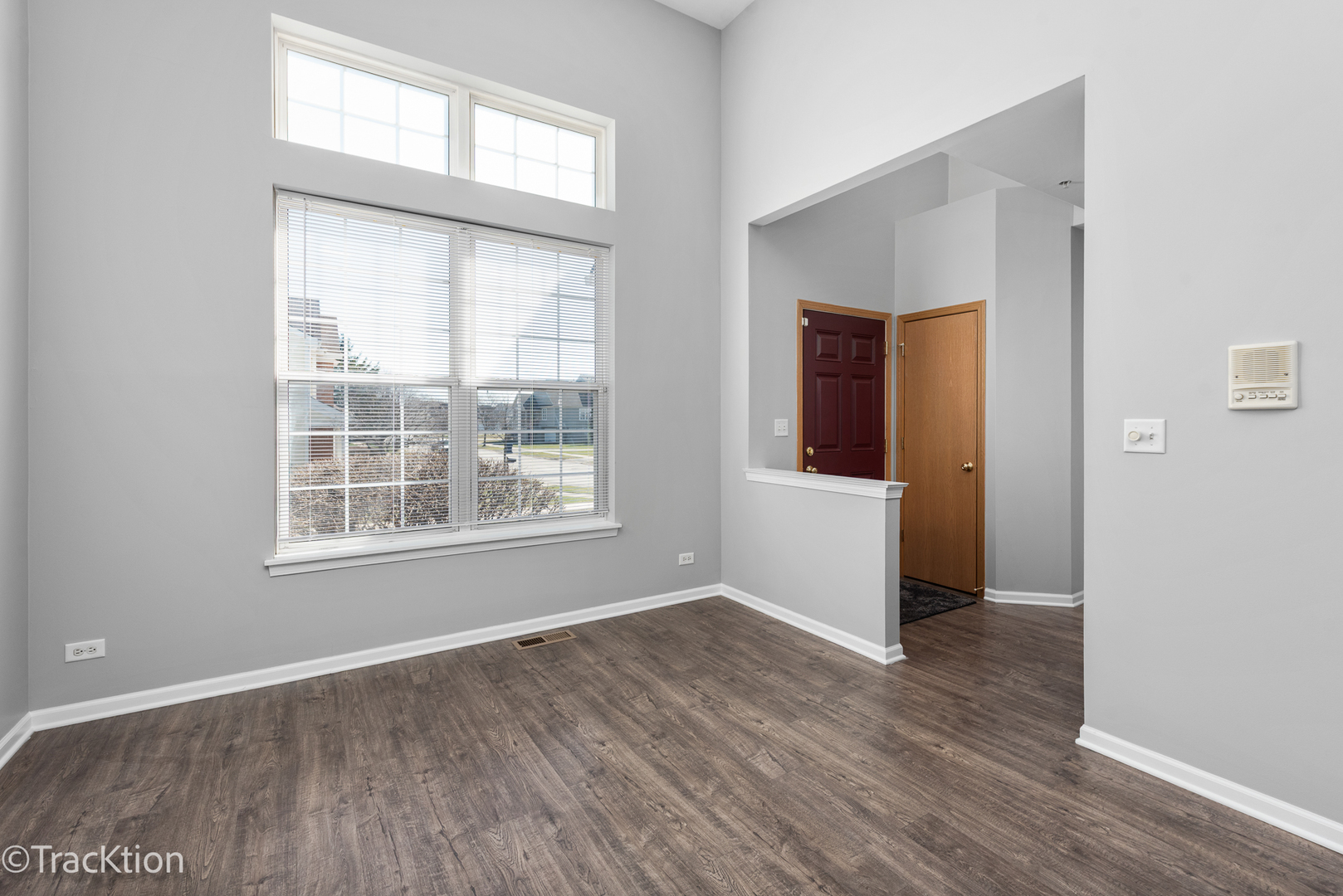 21602 Dogwood Road, Unit 1184 Matteson, IL 60443 - Photo 2 of 15 an empty room with wooden floor and windows