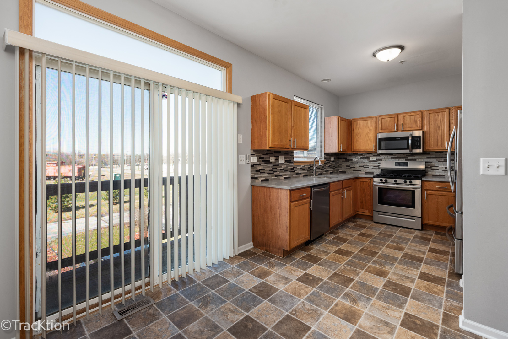 21602 Dogwood Road, Unit 1184 Matteson, IL 60443 - Photo 7 of 15 a kitchen with stainless steel appliances granite countertop a stove a sink and a refrigerator