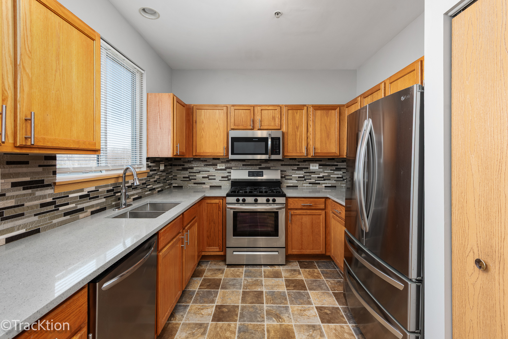 21602 Dogwood Road, Unit 1184 Matteson, IL 60443 - Photo 8 of 15 a kitchen with stainless steel appliances a stove a sink and a refrigerator