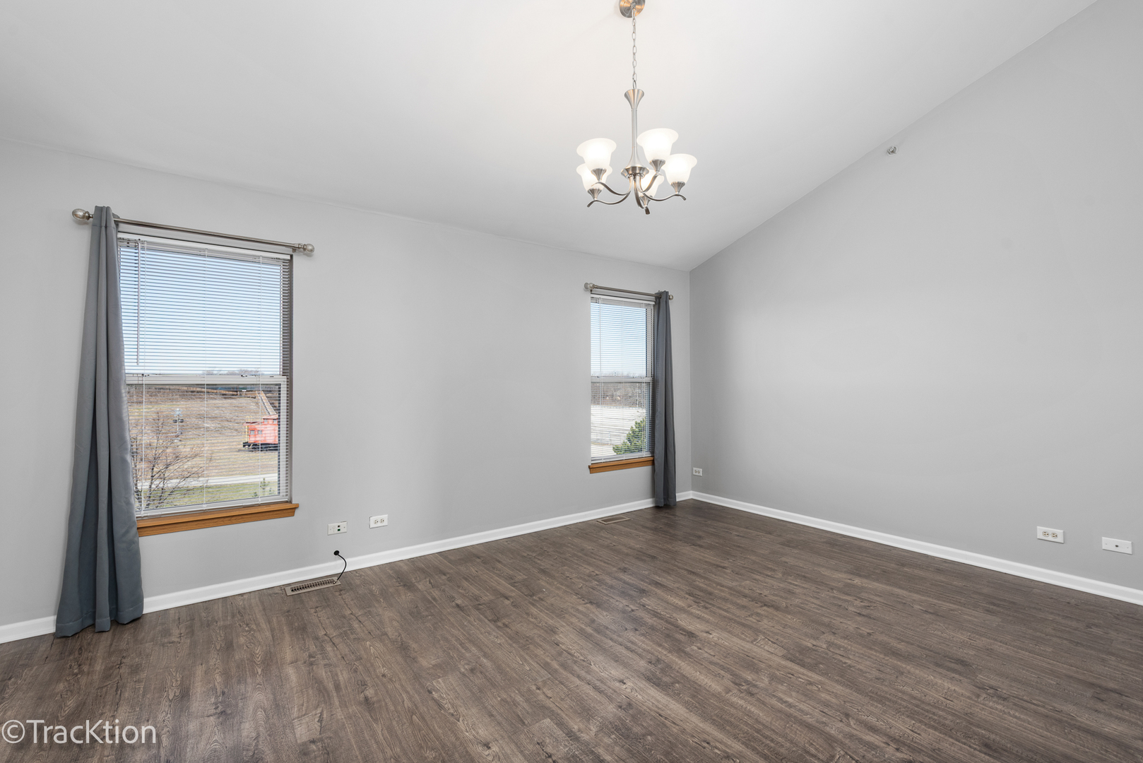 21602 Dogwood Road, Unit 1184 Matteson, IL 60443 - Photo 10 of 15 an empty room with wooden floor chandelier and windows