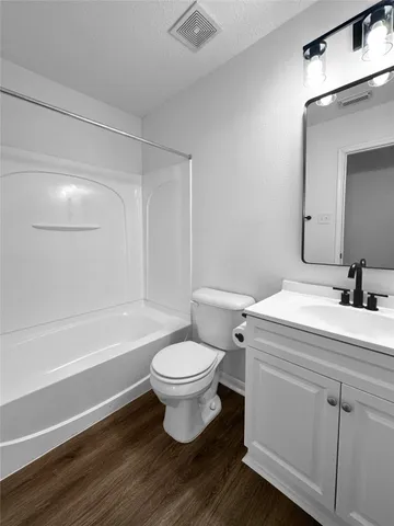 a bathroom with a double vanity sink toilet and shower
