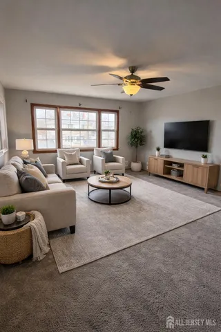 a living room with furniture and a flat screen tv