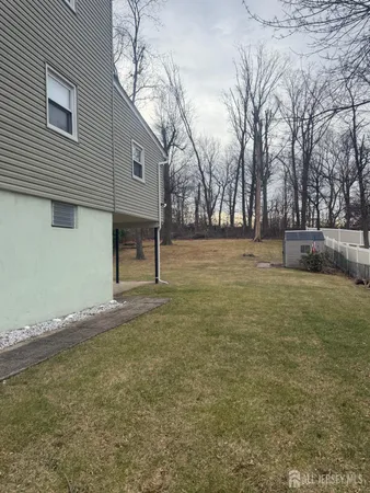 a view of a yard with a large tree