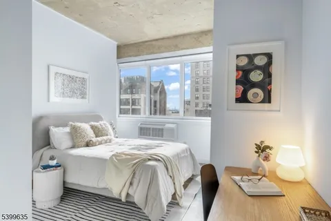 a bedroom with a bed and a table