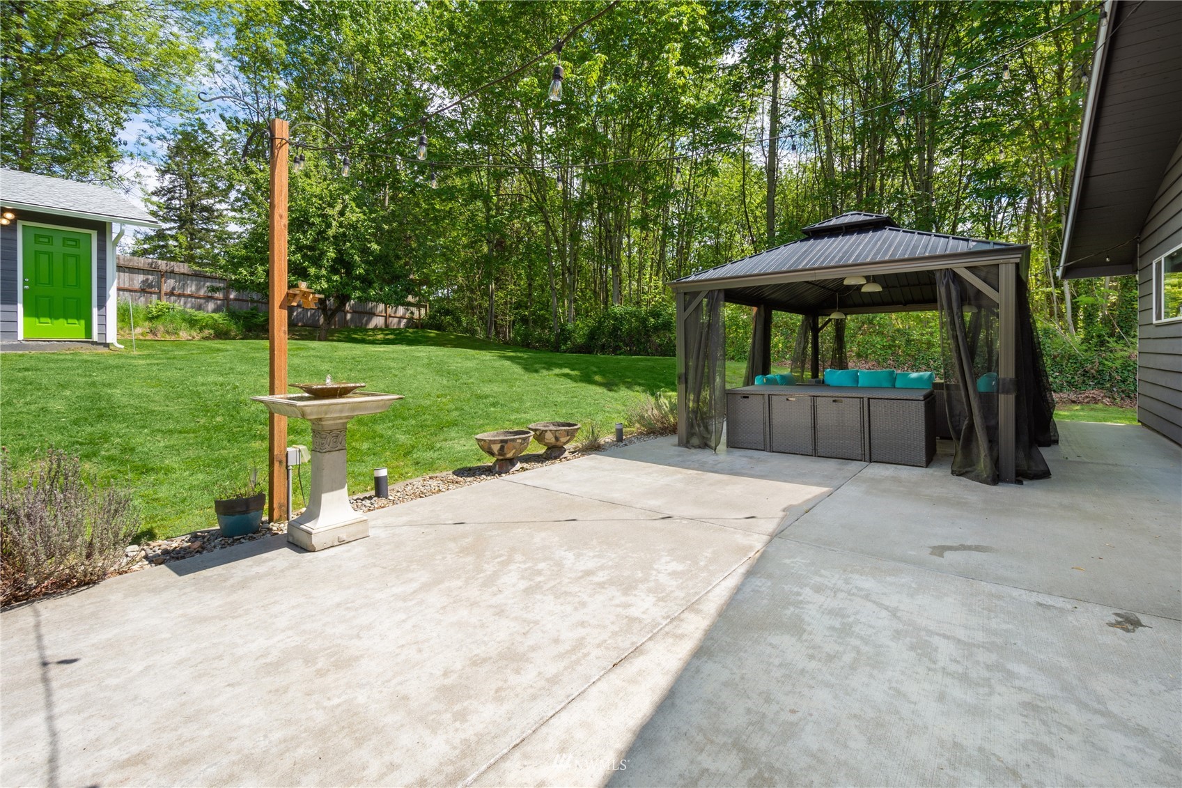 16442 111th Avenue Southeast Renton, WA 98055 - Photo 23 of 40 a view of a garden with a bench and trees