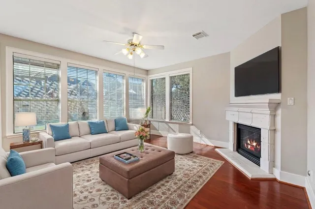 a living room with furniture a fireplace and a flat screen tv