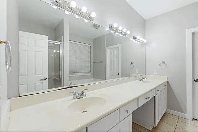 a bathroom with a sink double vanity and a mirror