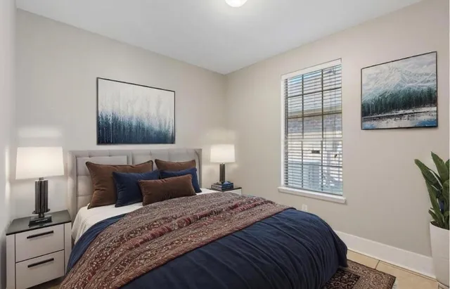 a bedroom with a bed and a window