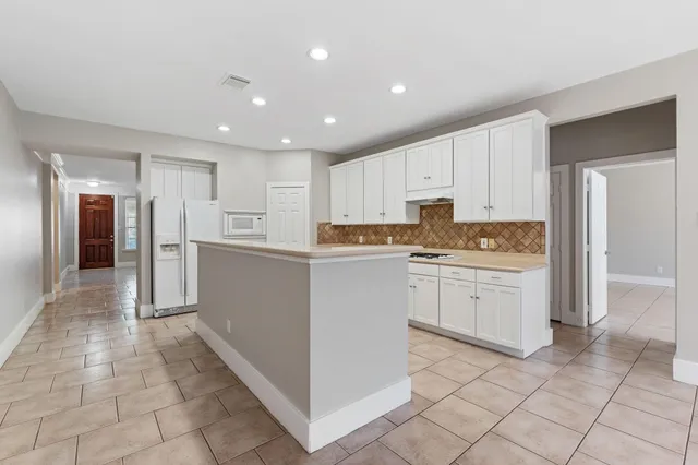 a kitchen with a refrigerator and a sink