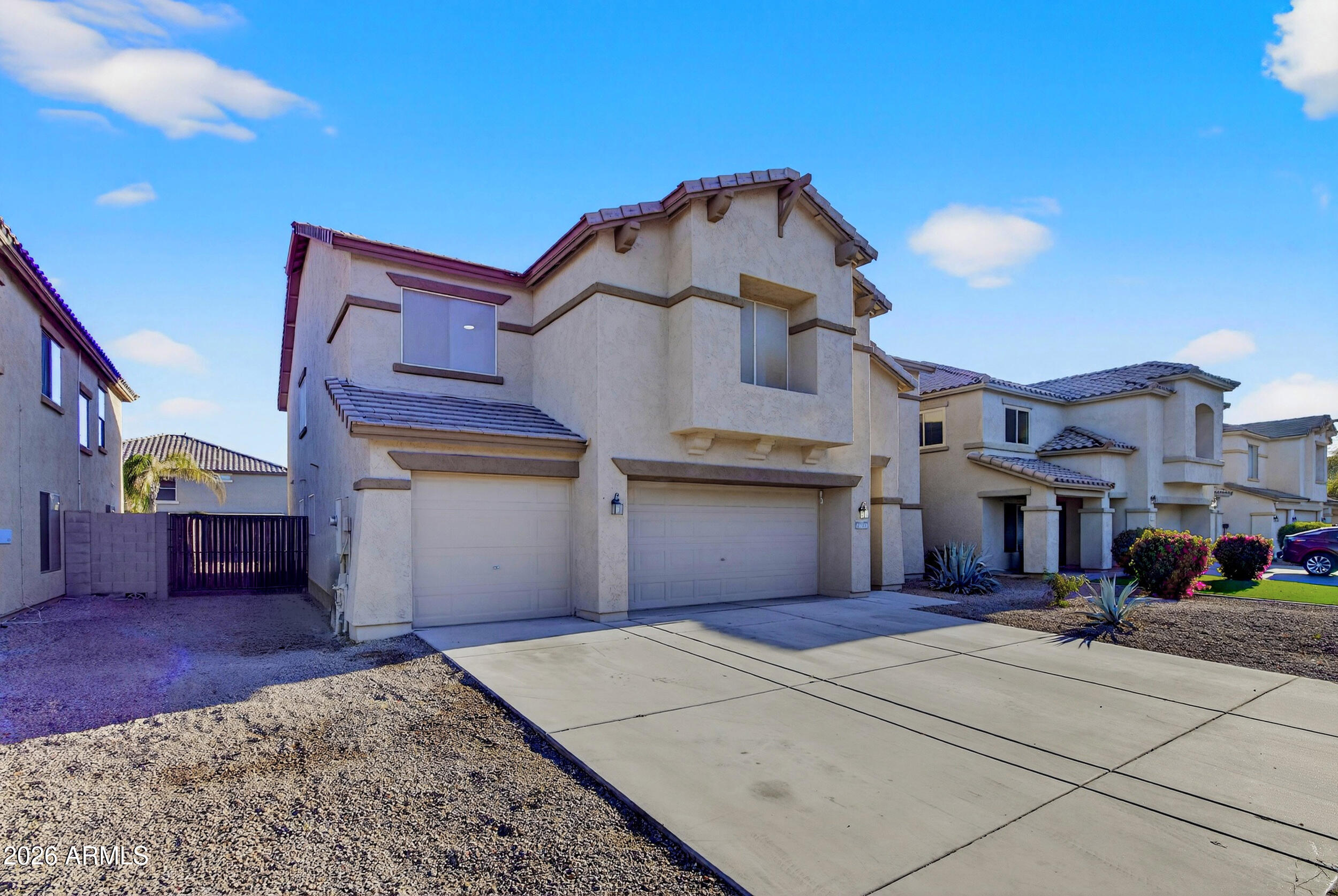 43620 West Cowpath Road Maricopa, AZ 85138 - Photo 2 of 60 a front view of a house with a yard