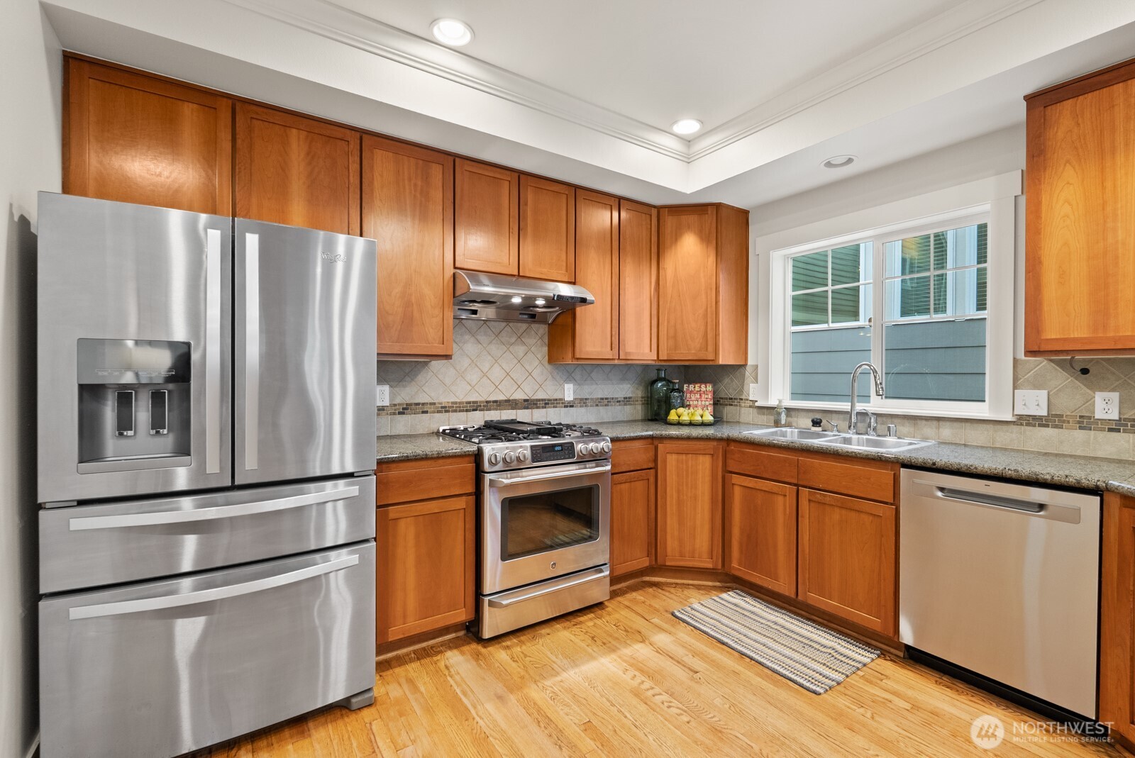 121 21st Avenue East, Unit C Seattle, WA 98112 - Photo 17 of 38 a kitchen with stainless steel appliances granite countertop a refrigerator a stove and a sink