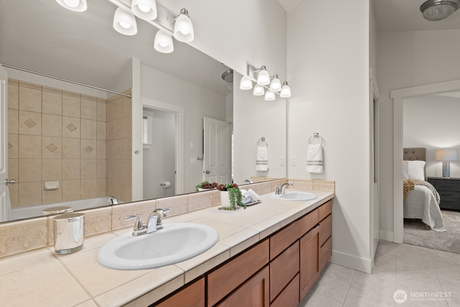 121 21st Avenue East, Unit C Seattle, WA 98112 - Photo 24 of 38 a bathroom with a double vanity sink and a mirror
