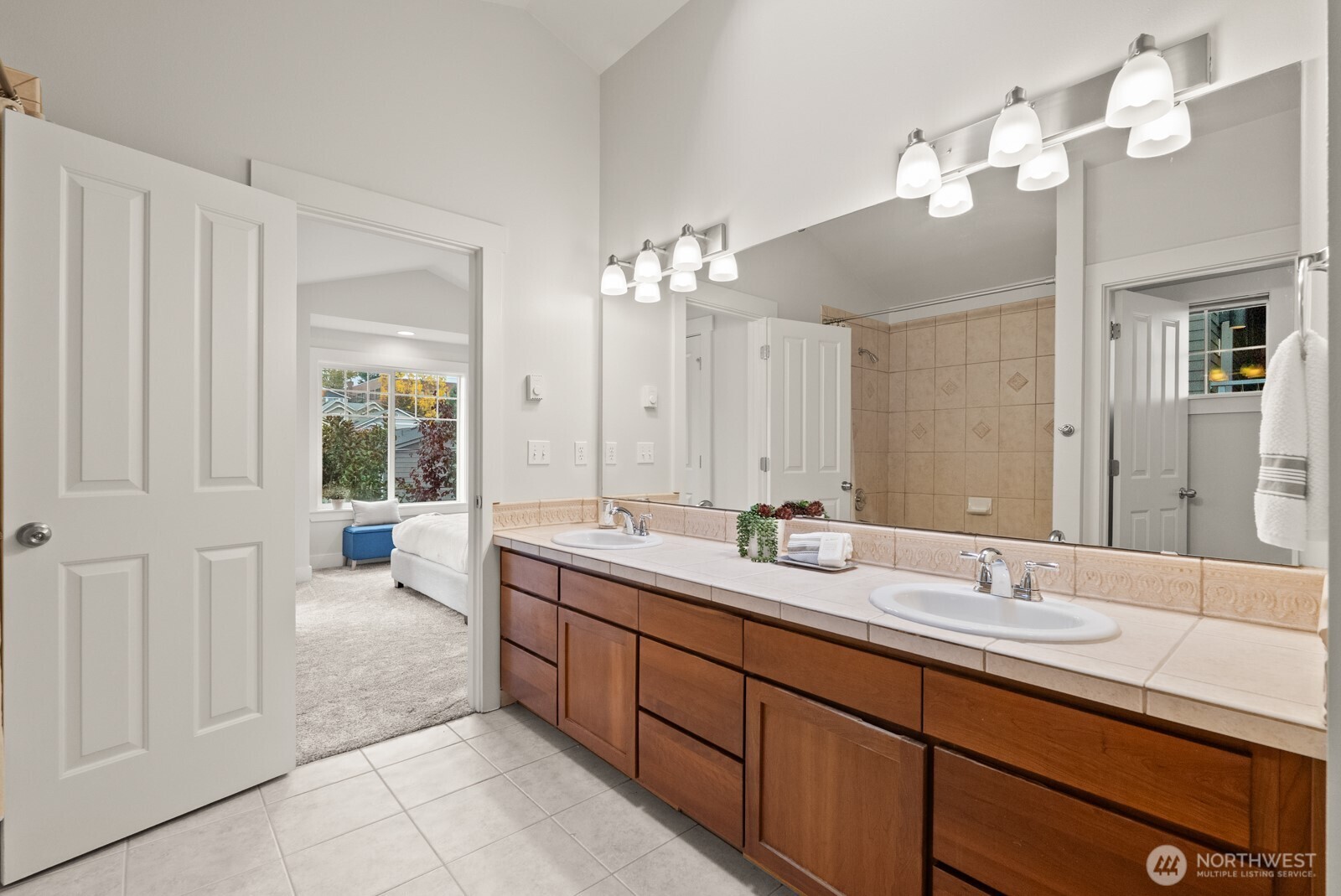 121 21st Avenue East, Unit C Seattle, WA 98112 - Photo 25 of 38 a spacious bathroom with a double vanity sink a mirror and a shower