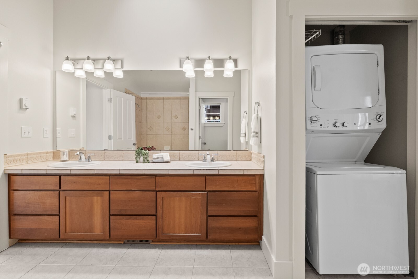 121 21st Avenue East, Unit C Seattle, WA 98112 - Photo 28 of 38 a bathroom with a double vanity sink and a mirror