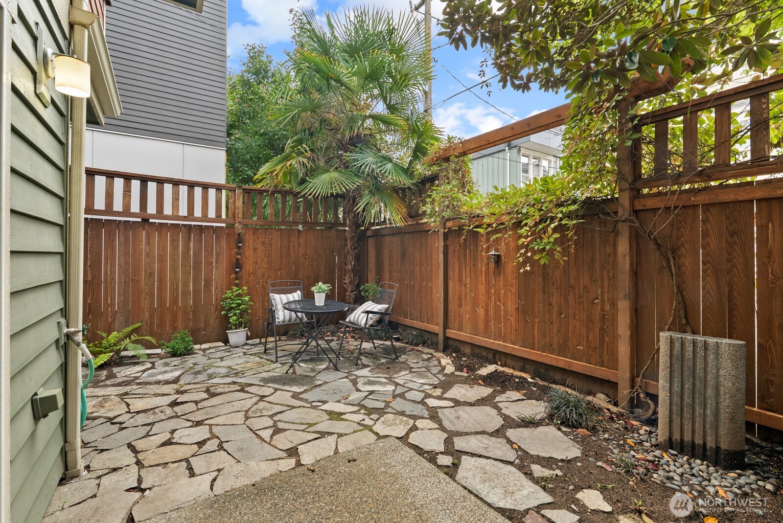 121 21st Avenue East, Unit C Seattle, WA 98112 - Photo 32 of 38 a backyard of a house with table and chairs