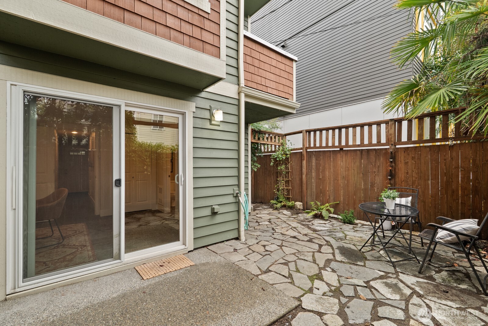 121 21st Avenue East, Unit C Seattle, WA 98112 - Photo 33 of 38 a backyard of a house with table and chairs