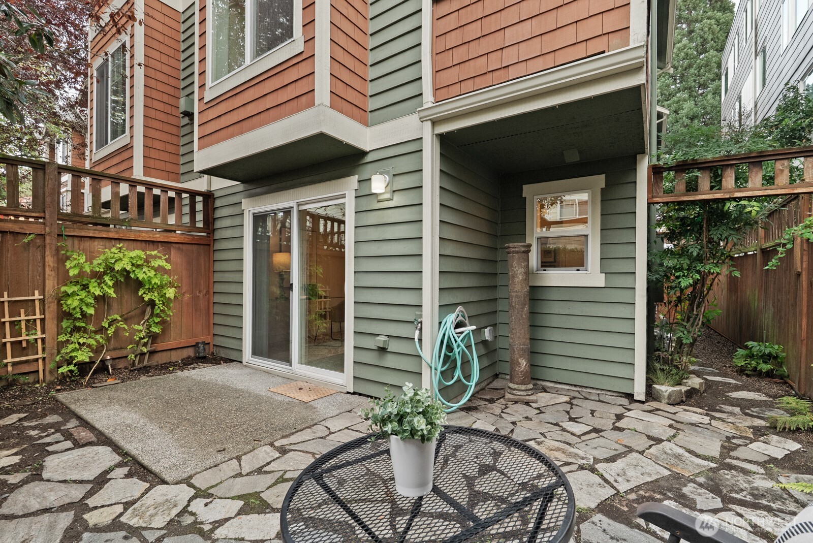 121 21st Avenue East, Unit C Seattle, WA 98112 - Photo 34 of 38 a house with potted plants in front of door