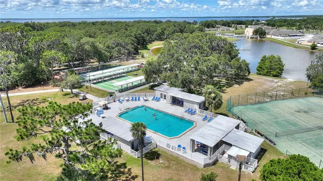 a living room with furniture and large windows