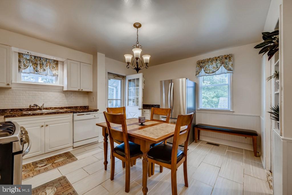 9422 Cross Road Nottingham, MD 21236 - Photo 12 of 31 a dining room with a wooden table and chairs