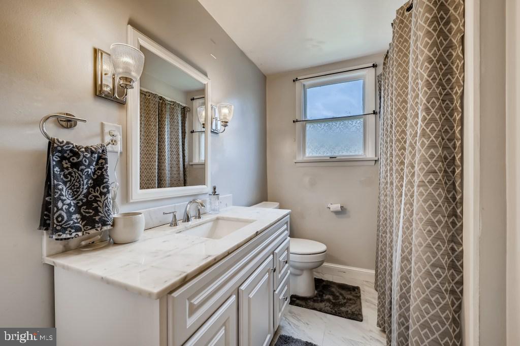 9422 Cross Road Nottingham, MD 21236 - Photo 20 of 31 a bathroom with a sink a toilet and a mirror