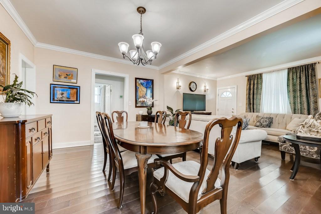 9422 Cross Road Nottingham, MD 21236 - Photo 10 of 31 a view of a dining room with furniture a chandelier and wooden floor