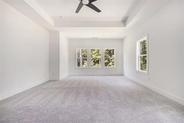 an empty room with windows and air conditioner