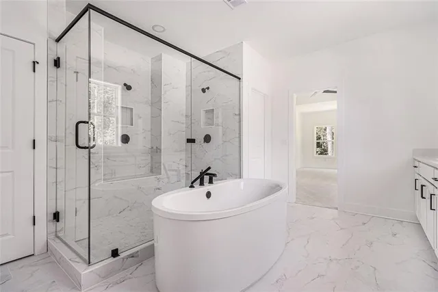 a bathroom with a bathtub and shower