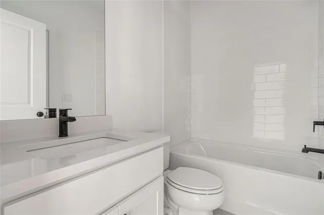 a bathroom with a sink a toilet and a bathtub