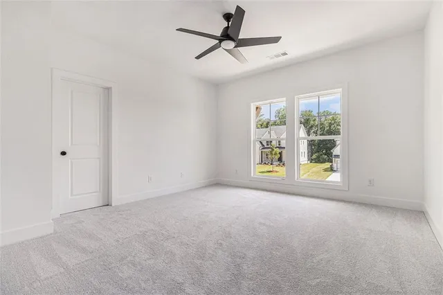 a view of room with window and ceiling fan