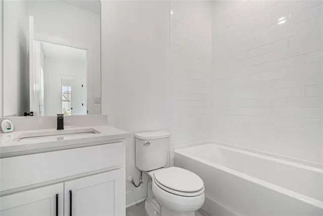 a bathroom with a sink a toilet and a bathtub