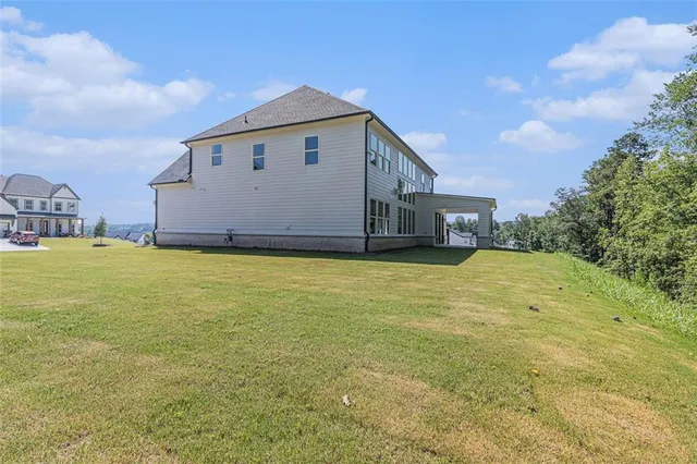 a big white house with a big yard plants and large trees