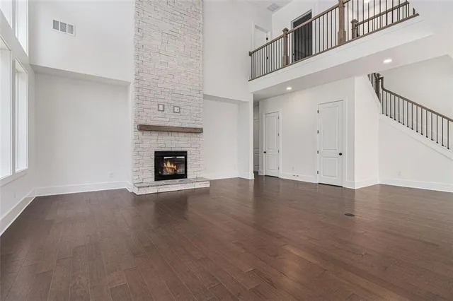 an empty room with wooden floor and fireplace