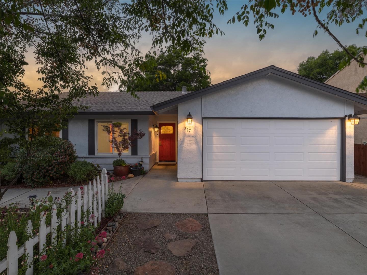 a front view of house with yard and green space