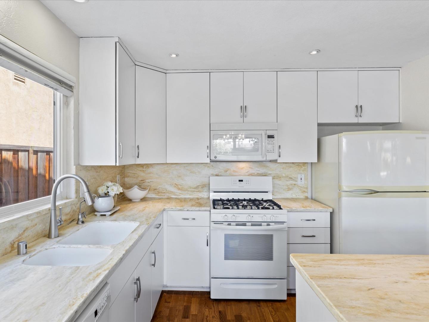 617 Lewis Road San Jose, CA 95111 - Photo 17 of 31 a kitchen with granite countertop a sink stove and white cabinets