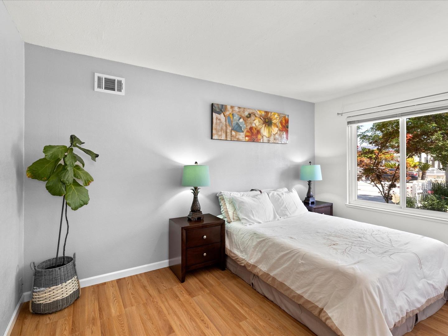 617 Lewis Road San Jose, CA 95111 - Photo 25 of 31 a bedroom with a bed and a potted plant