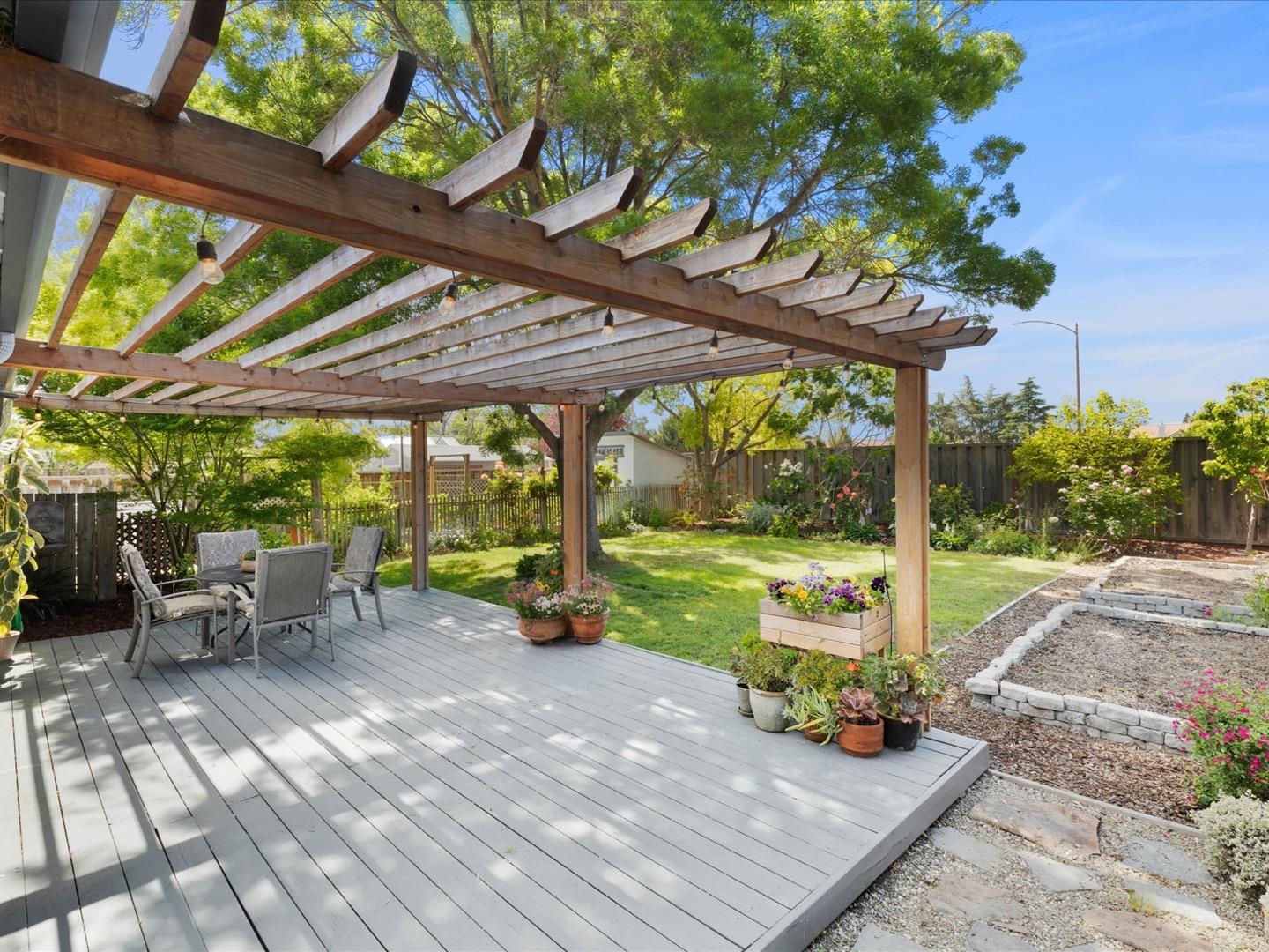 617 Lewis Road San Jose, CA 95111 - Photo 28 of 31 a view of a patio with table and chairs potted plants with wooden floor and fence