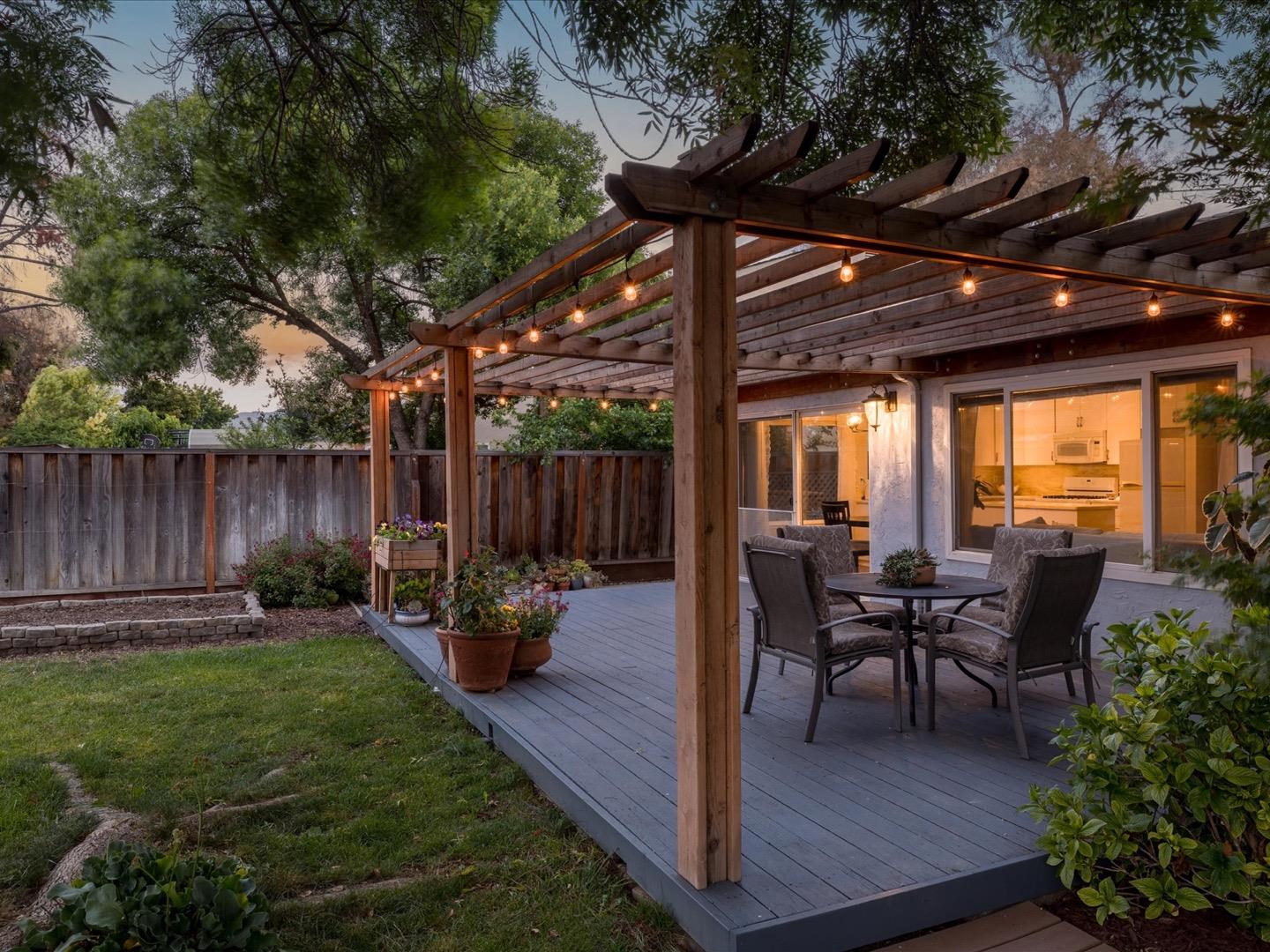 617 Lewis Road San Jose, CA 95111 - Photo 3 of 31 a view of a backyard with table and chairs potted plants and a large tree