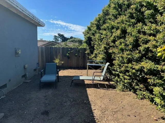 a view of a patio with table and chairs and potted plants