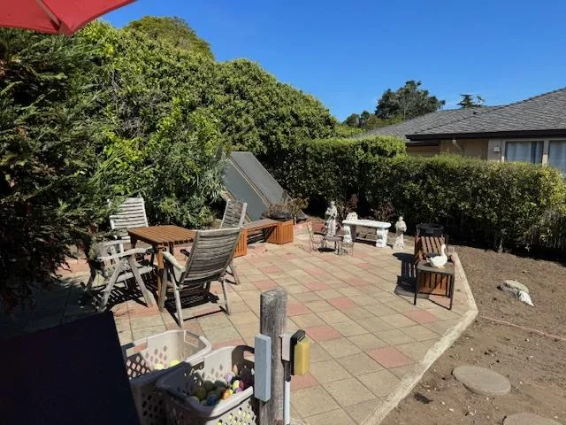 a view of a house with yard and sitting area