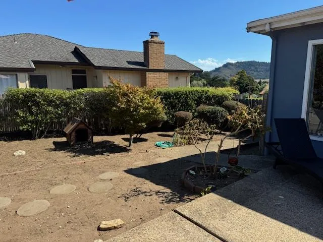 a view of a patio with table and chairs with wooden floor and plants