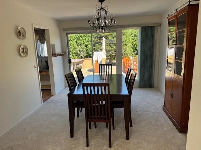 a view of a dining room with furniture wooden floor and a chandelier