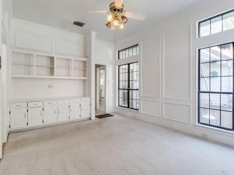 5910 Buffridge Trail Dallas, TX 75252 - Photo 12 of 24 an empty room with windows and cabinet