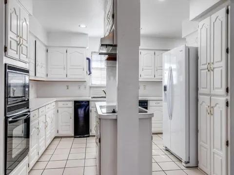 5910 Buffridge Trail Dallas, TX 75252 - Photo 17 of 24 a kitchen with stainless steel appliances granite countertop a refrigerator and a stove top oven